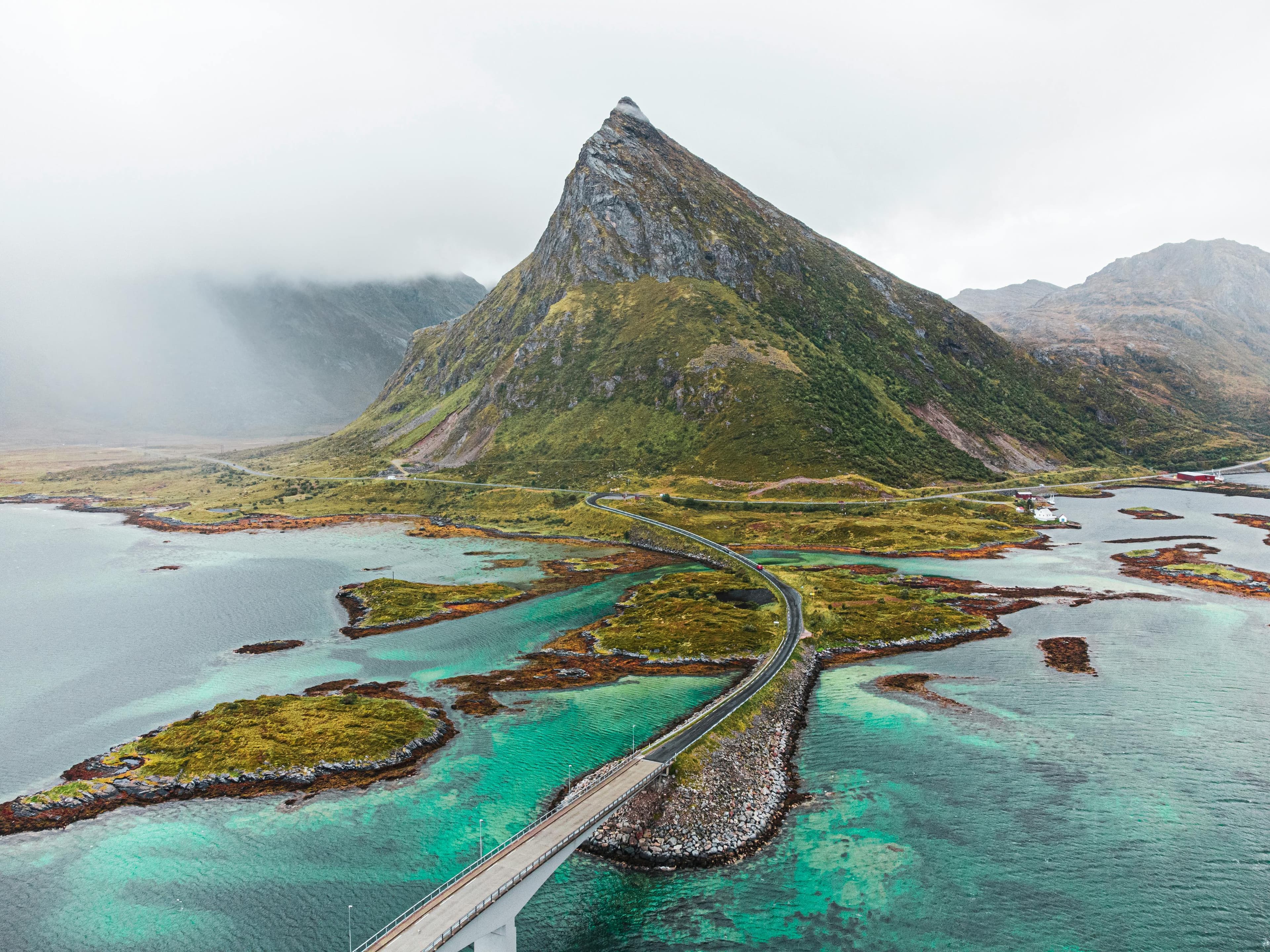Scenic road through mountains and coastline in Lofoten